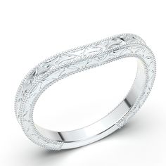 a white gold wedding band with intricate engraving