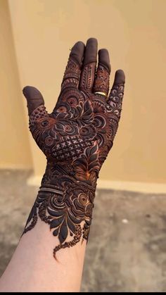 a woman's hand with henna on it