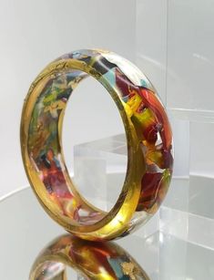 Elevate your accessory game with our Tall Round Spring Bangles. Handcrafted with vibrant colored resin and luxurious gold foil, these bangles are a must-have for any jewelry collection. Luxury Multicolor Jubilee Bracelet Bangle, Gold Foil, Bangle Bracelets, Jewelry Collection, Jewelry Bracelets, Foil, Bangles, Gold, Jewellery Bracelets