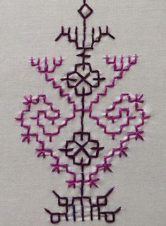 a close up of a piece of cloth with stitching on it and an embroidered design