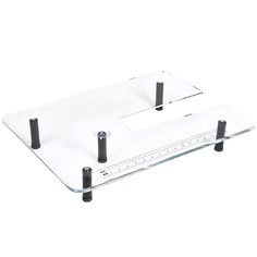 a clear glass table with two black legs and one ruler on the bottom that is measuring