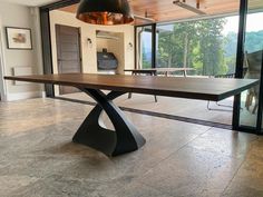 a dining room table in front of a sliding glass door