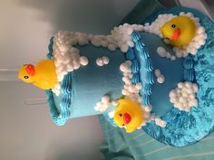 there is a cake that has rubber ducks on it