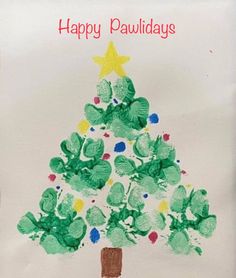 a child's handprinted christmas tree on a white card with the words happy pawdays