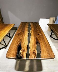 the table is made from wood and has two benches on each side with black metal legs