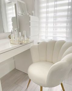 a white chair sitting in front of a mirror