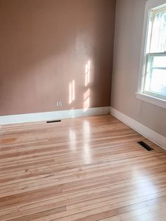 an empty room with hard wood floors and bare walls