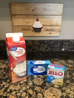 two boxes of jello and one carton of yogurt are sitting on the counter