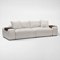 a white couch with four pillows on it