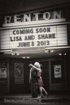 a man and woman embracing in front of a marquee for the movie reunion