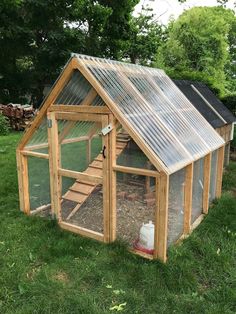 a small wooden chicken coop in the grass