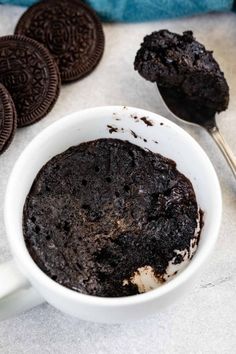 an oreo cookie and ice cream in a white cup