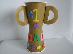 a brown vase with the number one dad written on it and stars painted on it