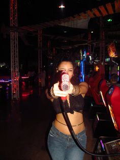 a woman holding a video game controller in her right hand