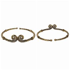 two gold bracelets with spiral designs on them