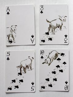 four playing cards with dogs drawn on them