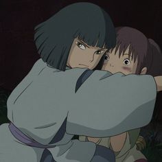 two anime characters hugging each other in the dark