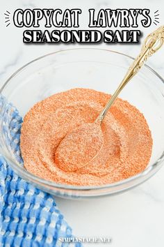 a bowl filled with seasoning next to a blue towel