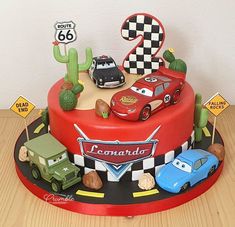 a birthday cake decorated with cars and numbers