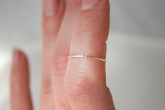 "One simple, super skinny solid gold stacking ring in your choice of 14k, 18k, or 22k gold. Stackable rings are so fun! The ring pictured has been created with the \"Lined\" texture. Please choose from: *Hammered *Lined *Round This listing is for one ring only, at the incredibly delicate width of 0.8 mm. Please indicate your texture choice from above as well as your ring size during check out. If you are unsure of your size as according to the US scale, simple choose \"US 000\" and let me know y Simple Tiny Yellow Gold Stackable Rings, Simple 14k Gold Midi Rings, Gold Stackable Rings, Gold Stacking Ring, Line Texture, Single Ring, Gold Ring Stack, Ring Pictures, One Ring