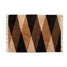 a brown and black rug with fringes on the bottom, in front of a white background