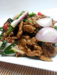 a white plate topped with meat and vegetables