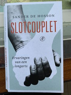 a book with two hands holding each other in front of a window and the words slotcouplet on it