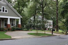 a street corner with a house and trees in the background