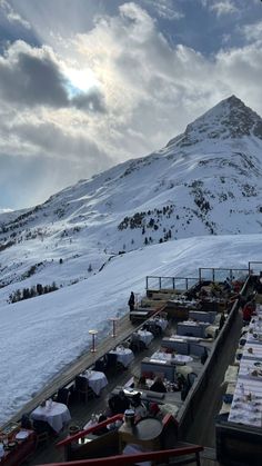 a mountain covered in snow next to a parking lot