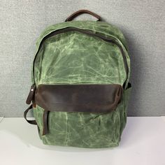 Gorgeous Green Waxed Canvas Backpack With Leather Accents. Two Water Bottle Pockets And Some Small Accessory Pockets On The Inside, And Hidden Pocket On The Back. Brand New, Never Used. Waxed Canvas Satchel Backpack With Waxed Finish, Coated Canvas Backpack With Large Capacity, Large Capacity Coated Canvas Backpack, Vintage Green Backpack For Everyday Use, Green Waxed Canvas Backpack, Waxed Finish Satchel Backpack For Everyday, Casual Leather Backpack With Waxed Finish, Everyday Waxed Satchel Backpack, Everyday Waxed Finish Satchel Backpack