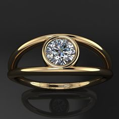 a gold ring with a white diamond in the center