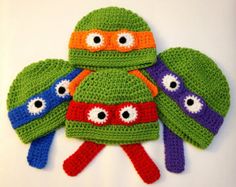 three crocheted hats and gloves with eyes on them, one is made to look like