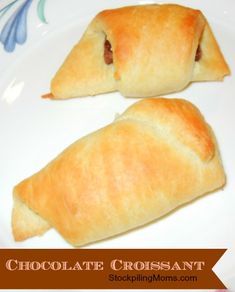 two croissants on a white plate with blue flowers