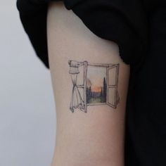 a woman's arm with a small tattoo on the left side of her body