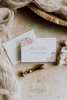 wedding stationery and flowers on a table next to a piece of paper that says thank you