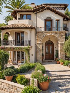 a large house with lots of windows and plants