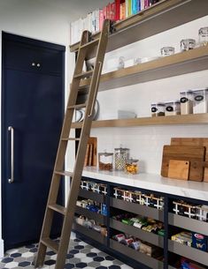 a ladder is in the middle of a kitchen with bookshelves and other items