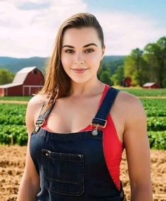 a woman in overalls is posing for a picture with a farm scene behind her