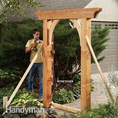 a man standing in front of a wooden arbor