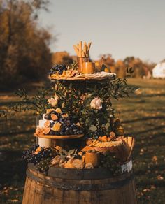 a wooden barrel filled with different types of food and drinks on top of it's sides