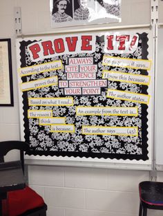 a bulletin board on the wall in a classroom with posters above it that read prove it