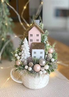 a white cup filled with christmas decorations on top of a table