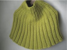 a yellow knitted hat with a wooden handle