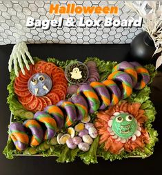 an assortment of fake food in a box on a table with the words halloween bagel and lox board