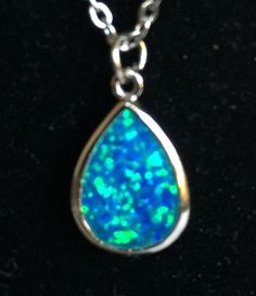 "Magical, glittery powder blue teardrop stone pendant, says China FD 925 on the back so it's manufactured by \"FD\" and it's made of 925 silver. It's hard to capture the texture of the pendant in my photos, but it's a sparkly blue with green iridescent highlights, and very smooth to the touch. The chain measures about 20\" and the pendant is about .625 by .5\". Please take a look at my storefront at: https://www.etsy.com/shop/FabFinds42?ref=seller-platform-mcnav I have a wide selection of one-of Blue Teardrop Pendant Necklace In Sterling Silver, Blue Sterling Silver Teardrop Pendant Necklace, Adjustable Blue Teardrop Drop Necklace, Adjustable Teardrop Blue Drop Necklace, Handmade Blue Teardrop Drop Necklace, Blue Pear-shaped Drop Necklace For Gift, Magical Pendant, Fantasy Pendant, Orange Bracelet