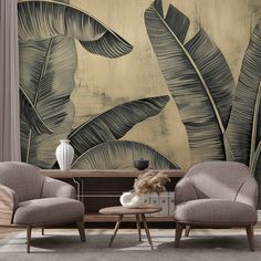 two chairs and a table in front of a wall with palm leaves on the background