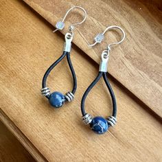 Blue Lapis beads are at the center of these teardrop leather earrings.  Enjoy these Nickel free silver plated earwires that are gentle on sensitive ears. - Genuine black leather - Lapis Beads - Silver spacers - Nickel free earwires - Lightweight, long wearing Find more of my earrings here: https://www.etsy.com/shop/fatcatbeads?section_id=42122010 Thank you for shopping with me! View all of my items here: www.fatcatbeads.etsy.com Elegant Teardrop Leather Jewelry, Everyday Blue Leather Jewelry, Elegant Blue Leather Jewelry, Lapis Earrings Silver, Lapis Earrings, Cute Accessories, Earrings Cute, Lightweight Earrings, Blue Lapis