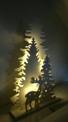 a lighted christmas tree in the shape of a deer