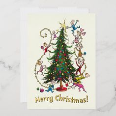 a christmas card with an image of a tree and elves around it, on a marble surface