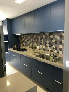 a kitchen with blue cabinets and white counter tops